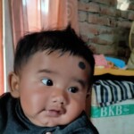 A cute baby in a smiling pose
