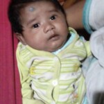 A cute baby in mother's lap