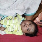A cute baby in mother's lap