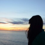 A Girl Looking at the Sunset near a Sea