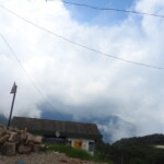 a small hut surrounded by clouds