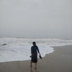a woman chasing the ocean waves