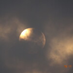 full moon behind clouds
