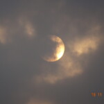 full moon peeping from behind clouds