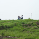 group of people in the top of a hill