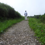man walking alone on a stone path