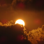 sun behind clouds