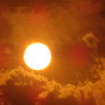full sun in dark clouds