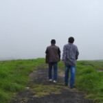 two man walking into meadows