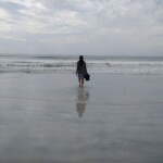 woman walking into the ocean waters