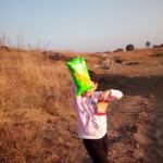 a child enjoying a packet of chips