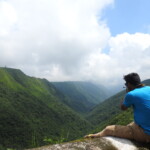 a man taking pictures of the mountains