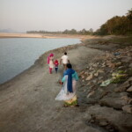 people walking near the river