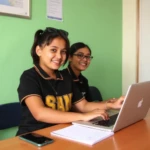 schoolgirls working on laptop